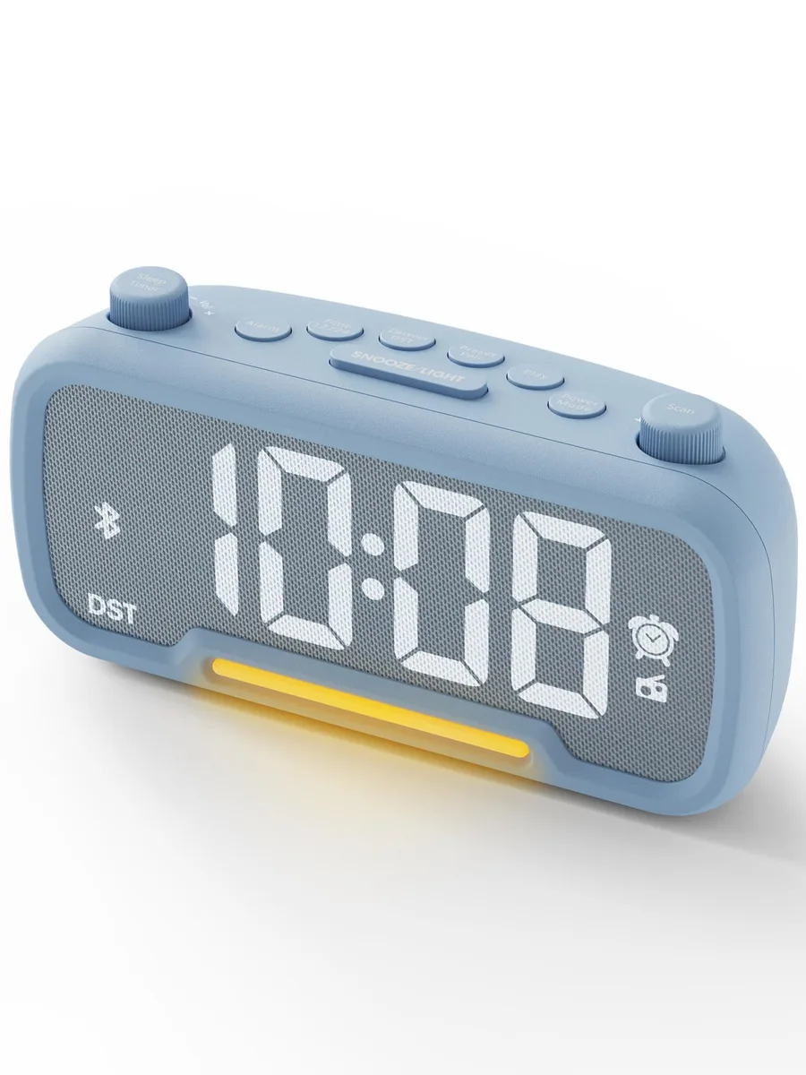 Rectangular fabric-covered clock radio with twin rotary knobs and large digital display