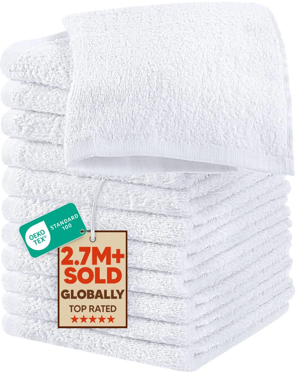 Stack of twelve white cotton washcloths folded flat