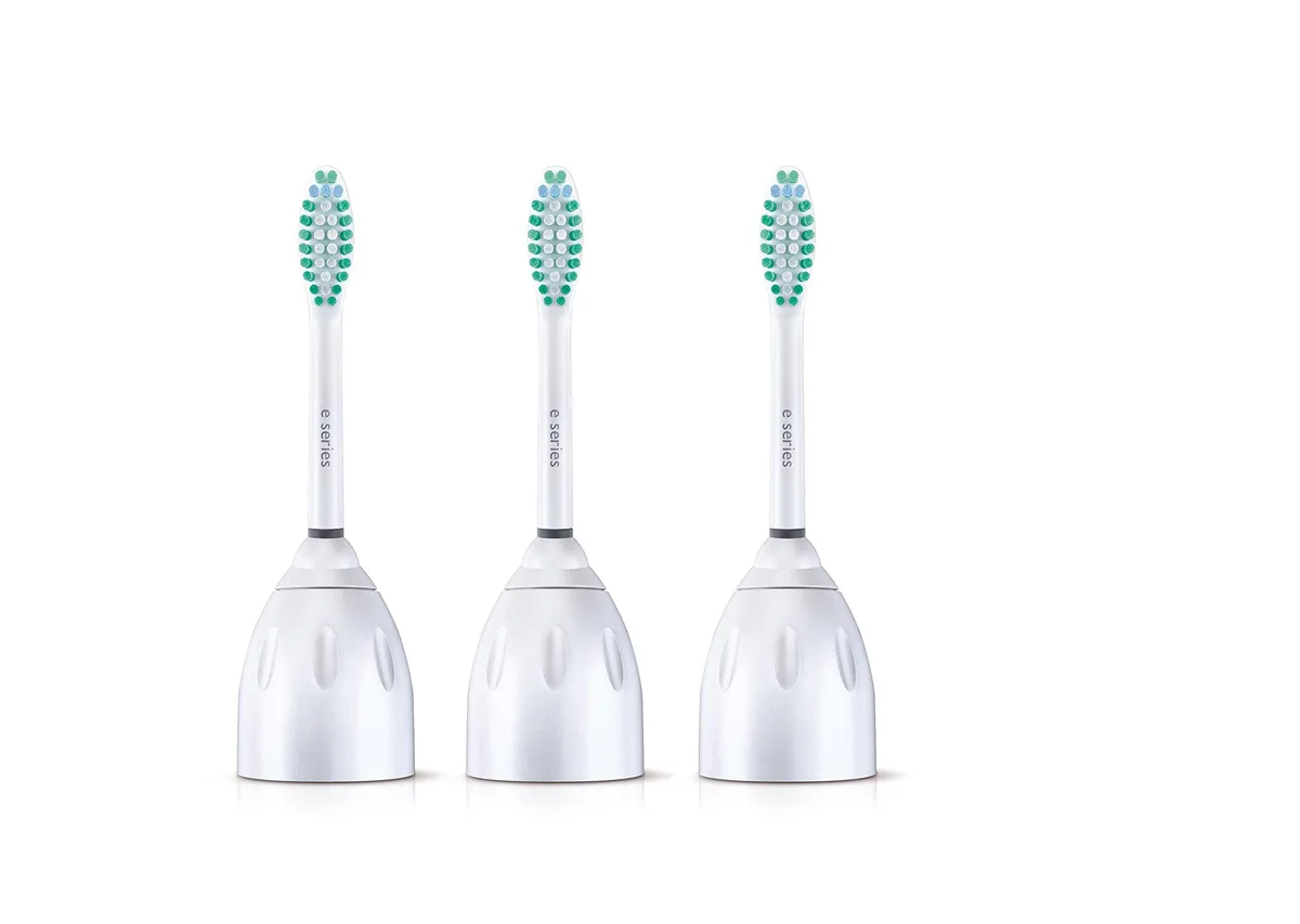 Three white oval brush heads with soft bristles