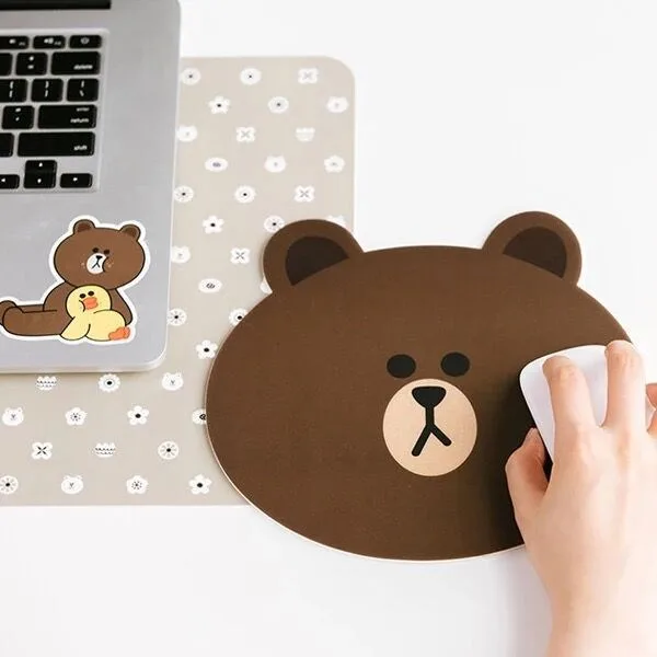 Small round brown mouse pad with a cute bear face design