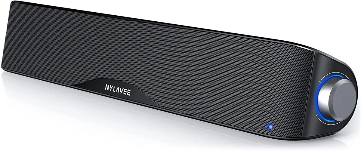 A black rectangular soundbar on a desk, USB cable attached