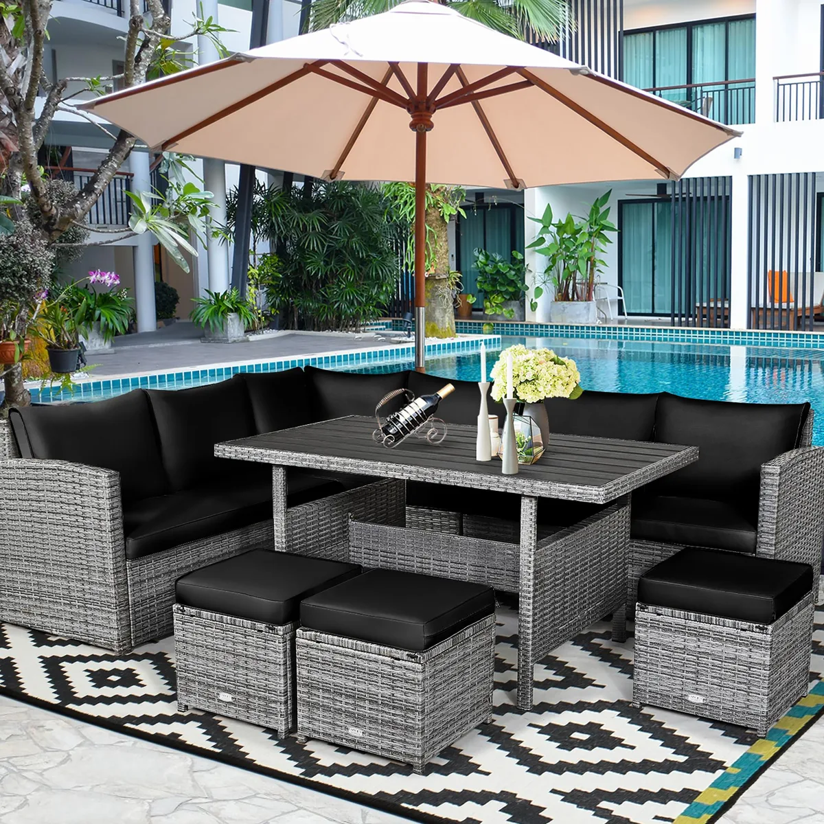 Black seven-piece rattan dining set with corner chairs, ottomans and table