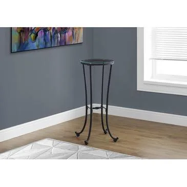 Round accent table with hammered black metal base and clear tempered glass top