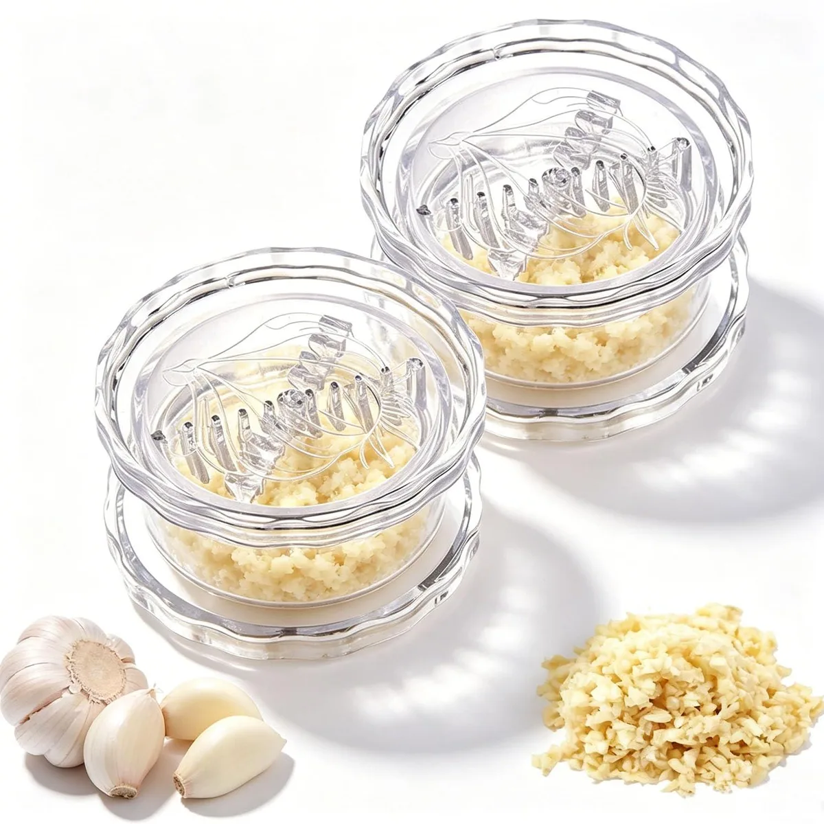 Two clear plastic garlic twisters, cylindrical with twist lids