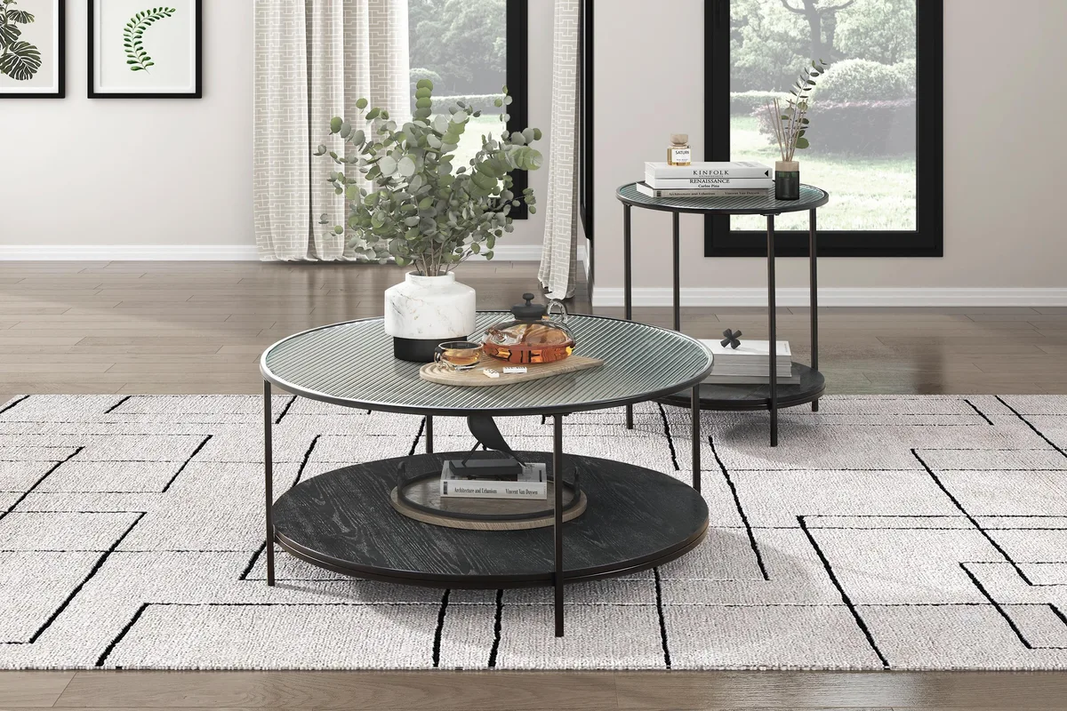 Two black tables with glass tops and metal frames, one larger coffee table and one smaller end table, each with a lower shelf