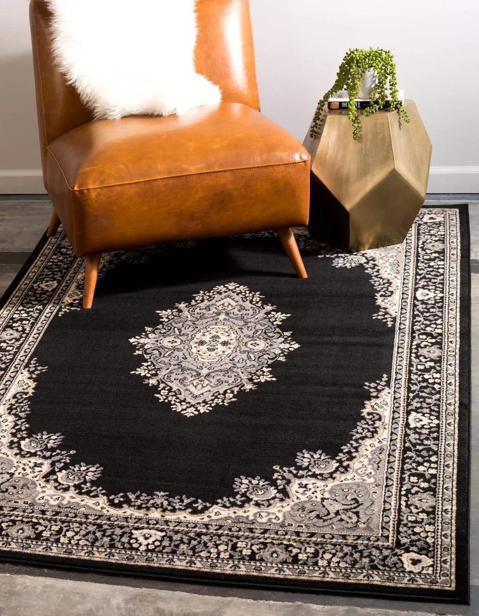 Rectangular black and beige machine-made rug, low pile, polypropylene surface, cotton backing, 125 by 185 cm