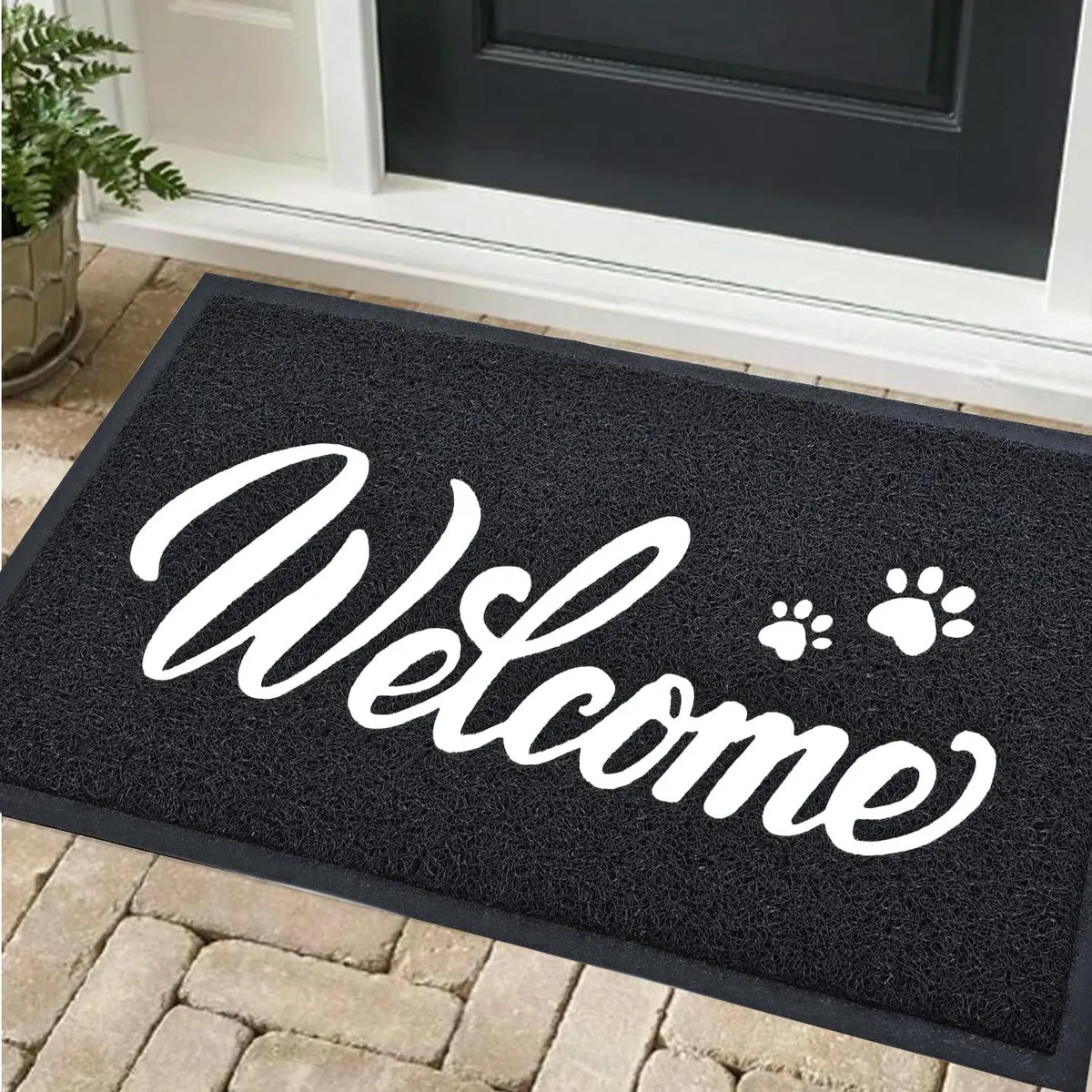 Rectangular black and white doormat with WELCOME printed in centre, low-profile PVC construction