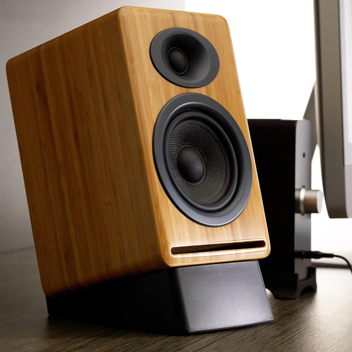 Pair of black rubber speaker stands with 15 degree tilt