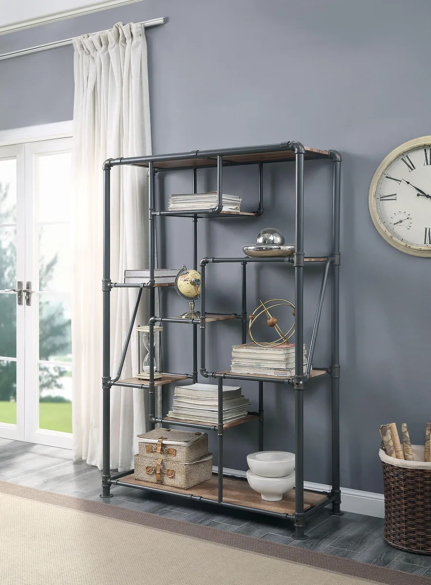 Tall industrial bookshelf with eight staggered wood shelves in antique oak finish on black metal pipe frame