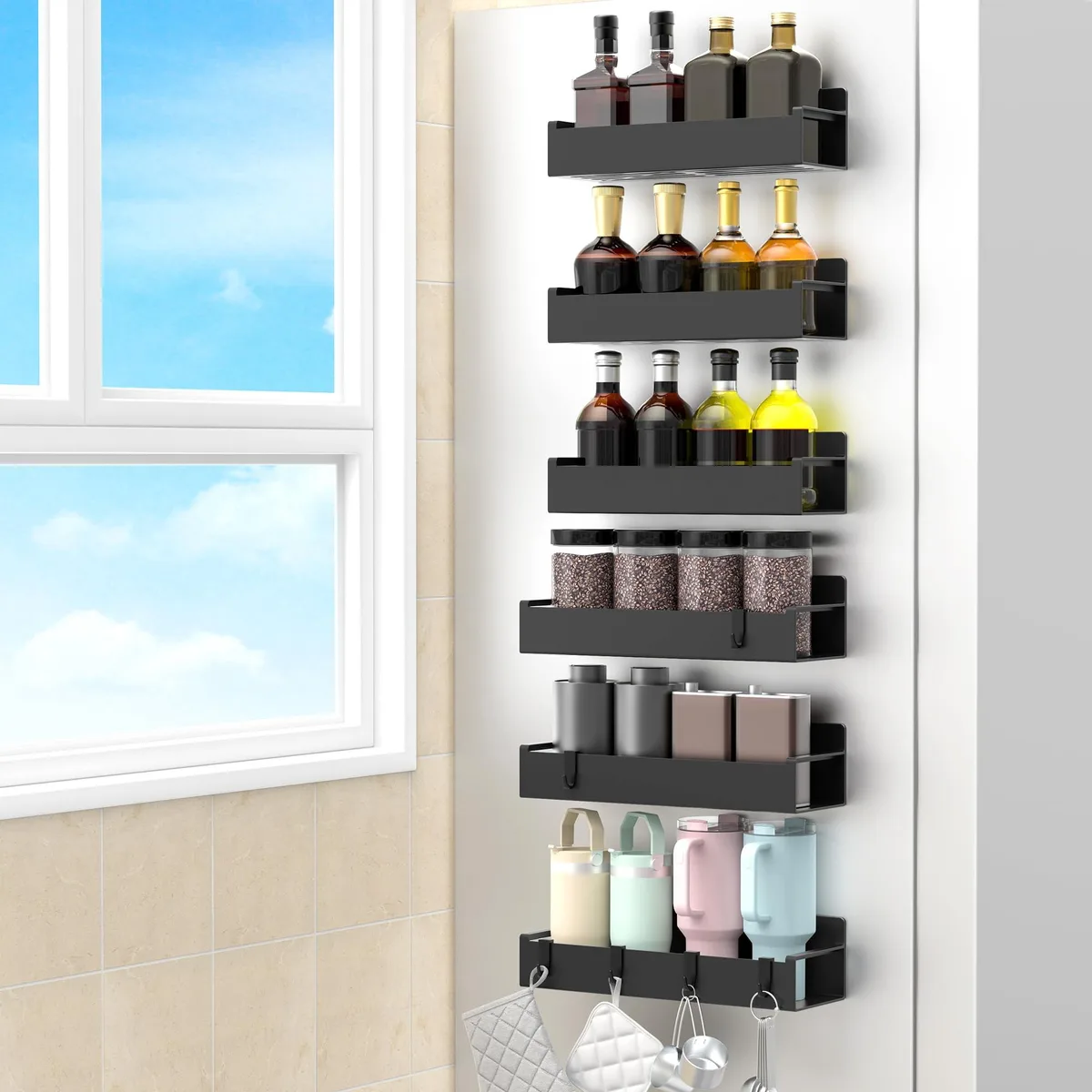 Six red magnetic spice racks with hooks arranged on a fridge side