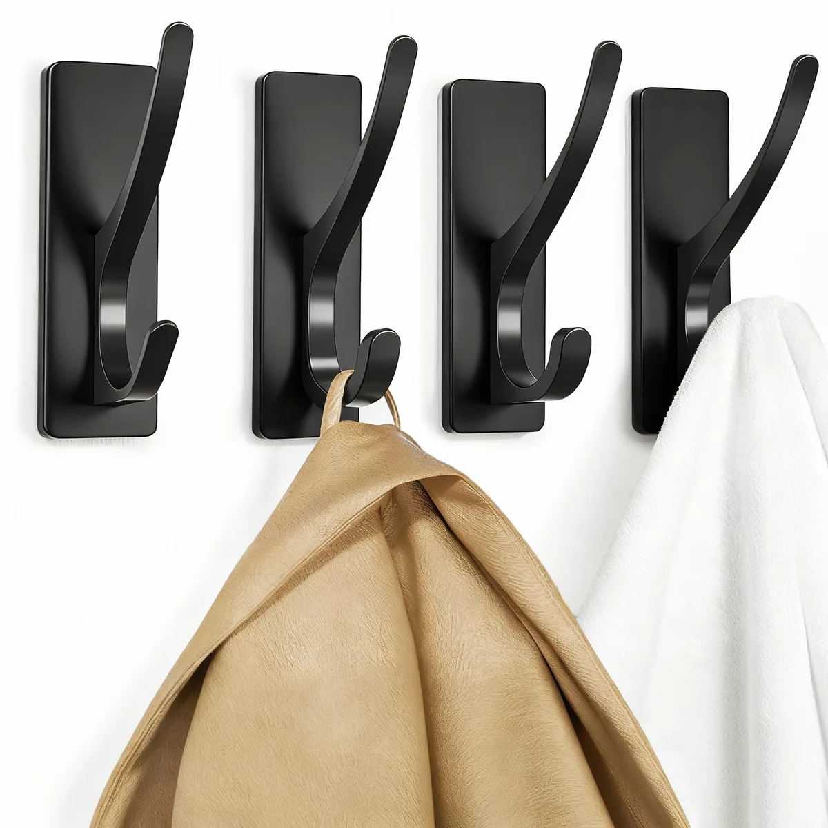 Four matte-black metal double hooks with brushed finish, self-adhesive backing