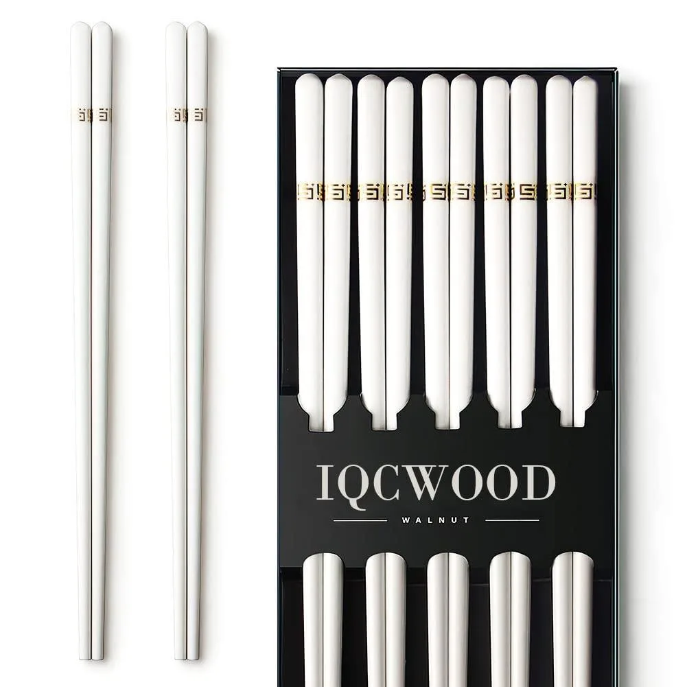 Five pairs of white bone china chopsticks with golden patterns in a case