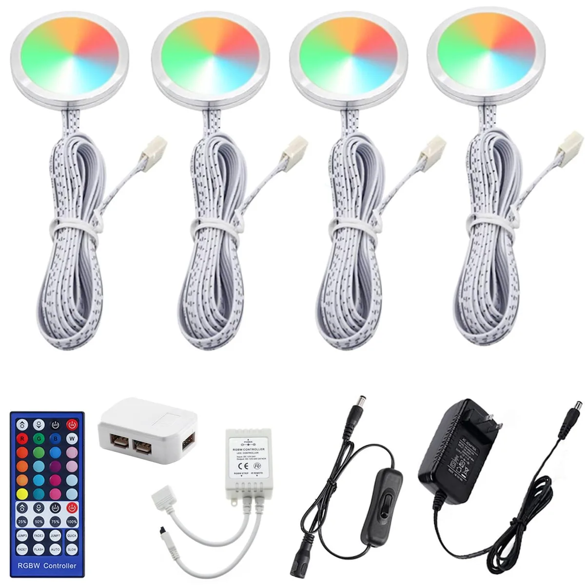 Four slim round puck lights with cables and a remote control