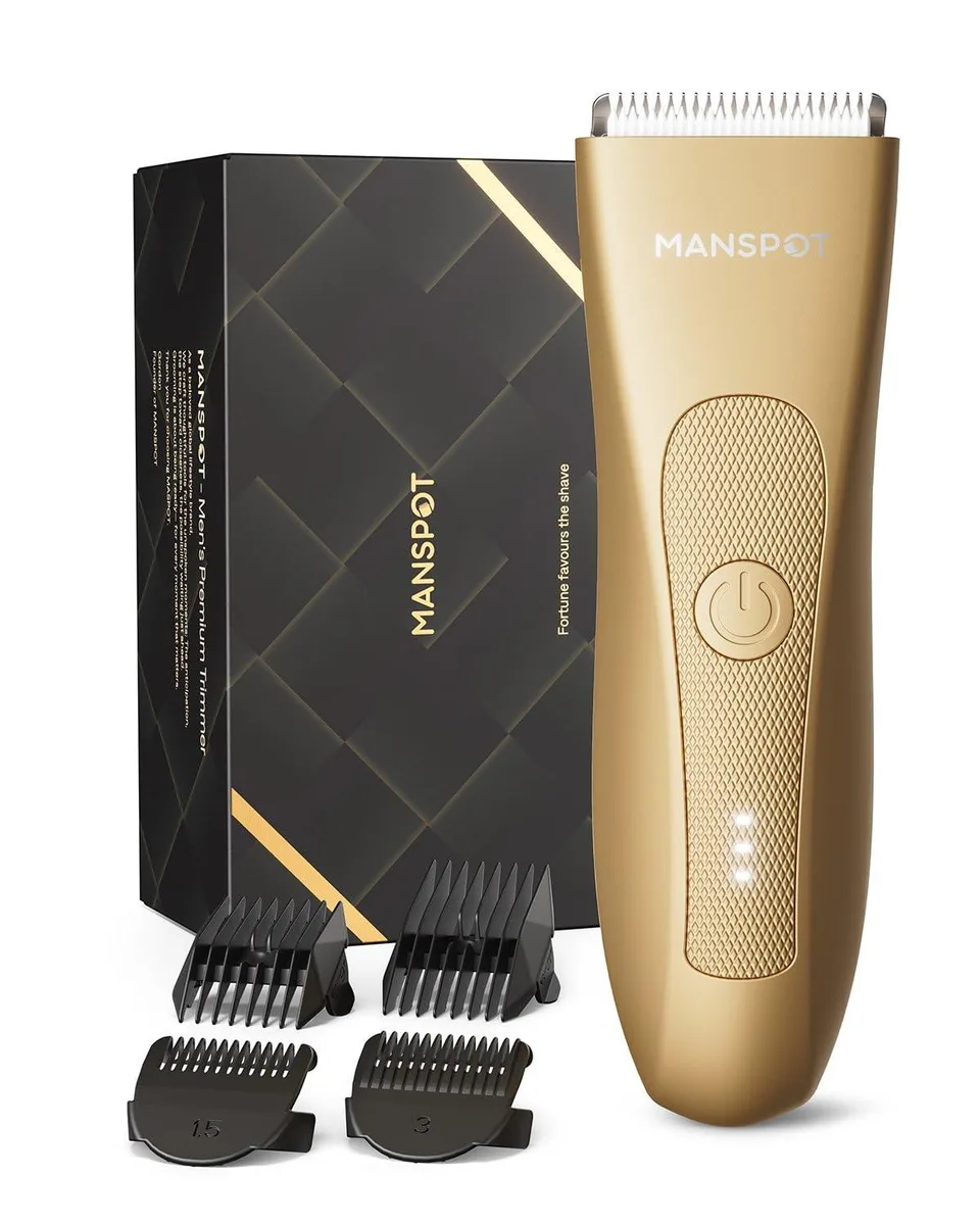 Gold finish compact body groomer with four guard combs attached