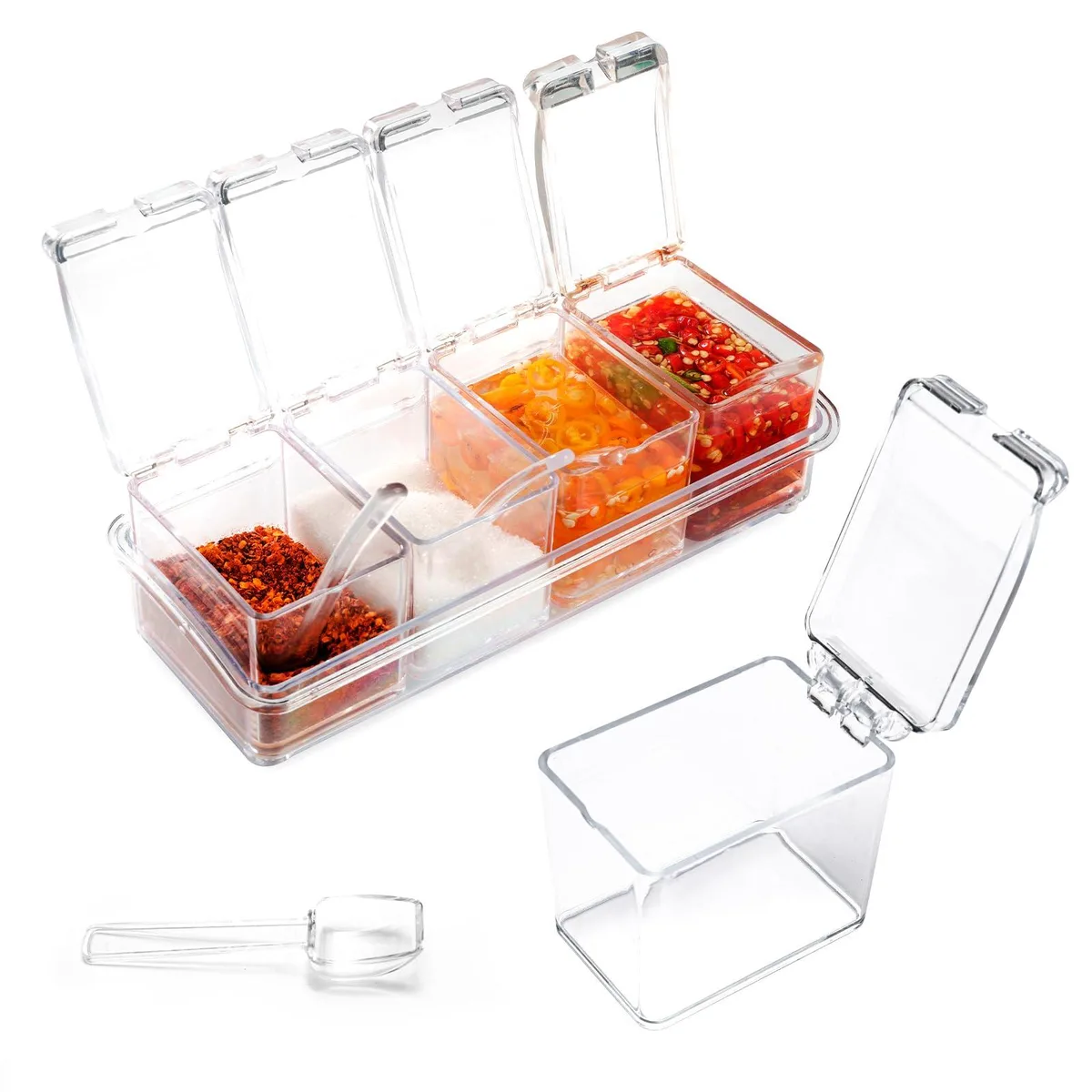 Four clear rectangular spice jars with lids and spoons on a transparent tray
