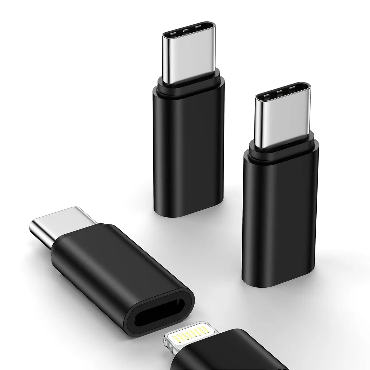 Three small black USB-C to Lightning adapters lying side by side