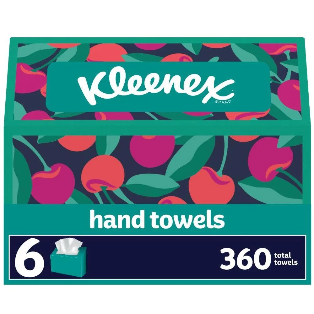 Six white rectangular boxes of single-fold paper hand towels on a plain background