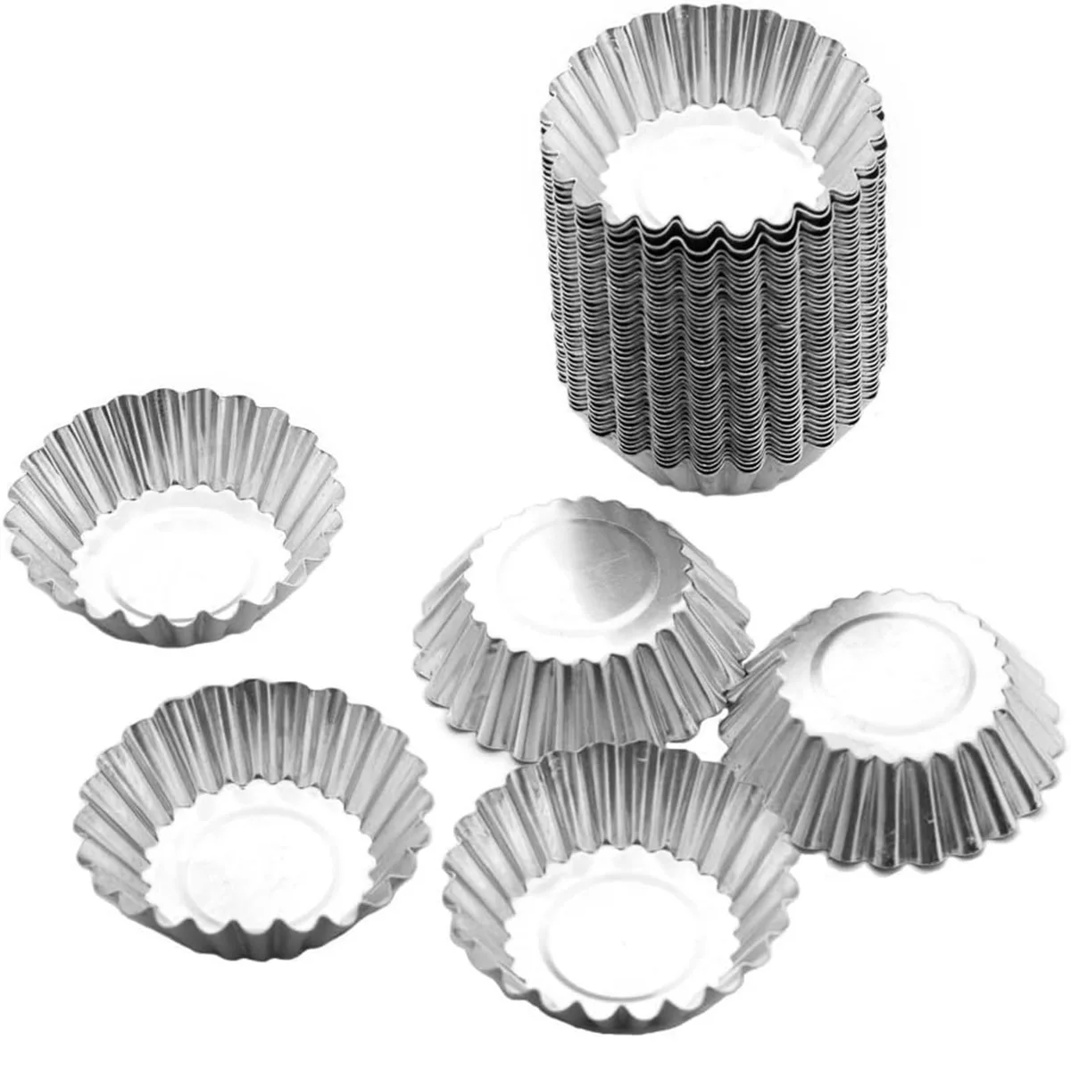 Fifty silver aluminium tart moulds with fluted edges stacked together