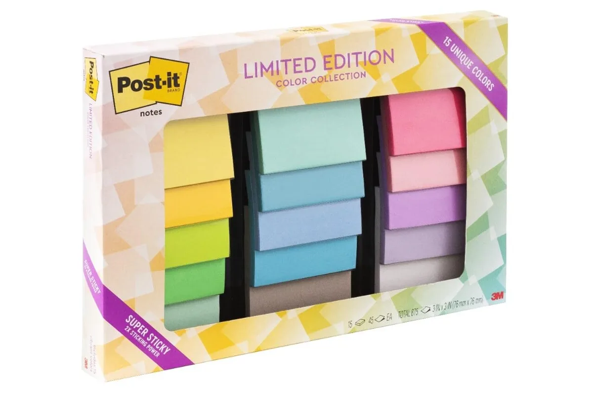 Cardboard box holding fifteen square sticky-note pads in assorted pastel colours