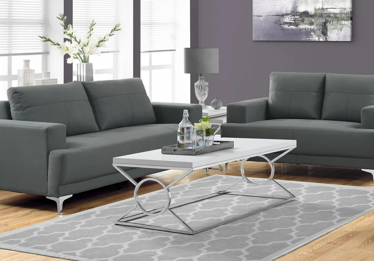 Rectangular glossy white coffee table with chrome metal circle and X-leg base