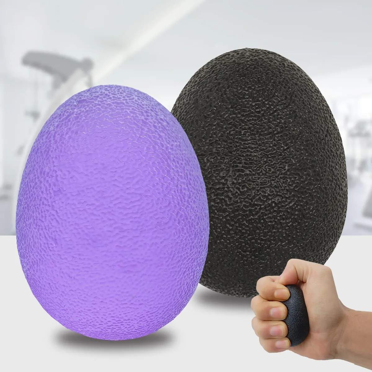 Two egg-shaped therapy balls, purple and black, with carrying bag