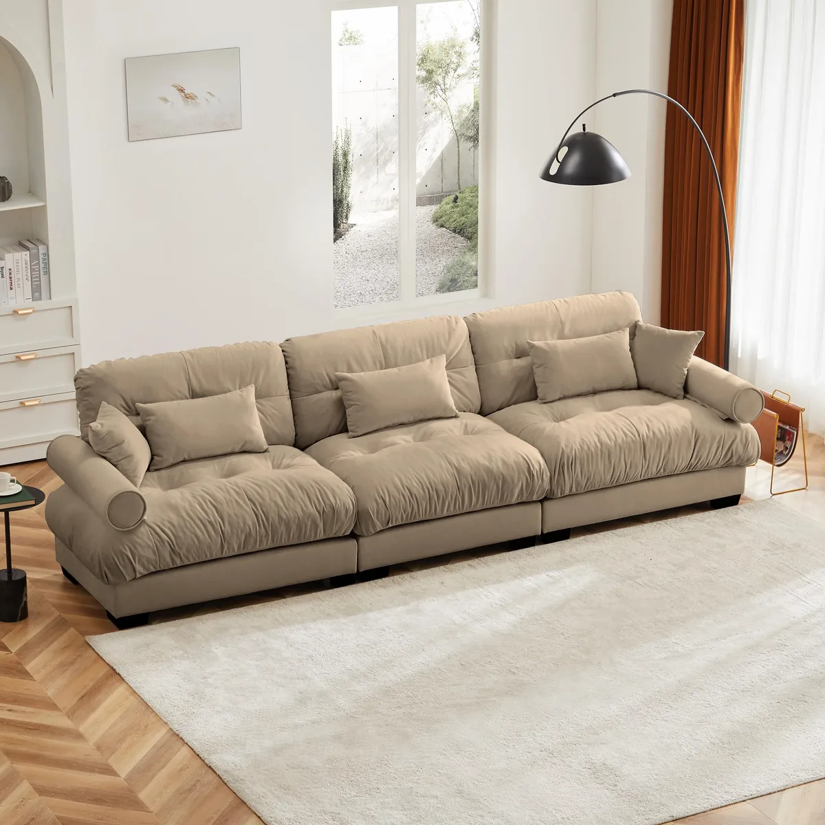 Camel velvet three-seater sofa with round bolster arms and matching pillows