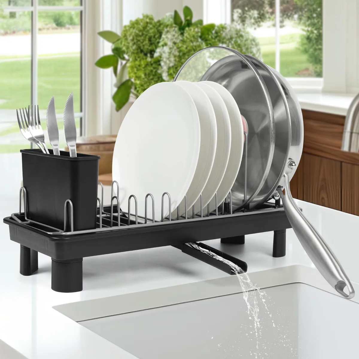 Black compact dish drying rack with detachable utensil holder and draining tray on countertop
