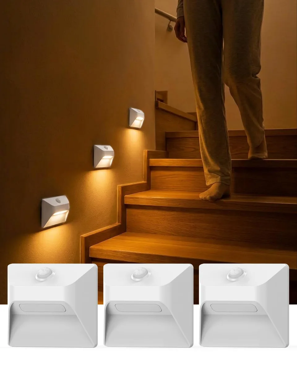 Three white rectangular LED stair lights with motion sensors, surface-mount design