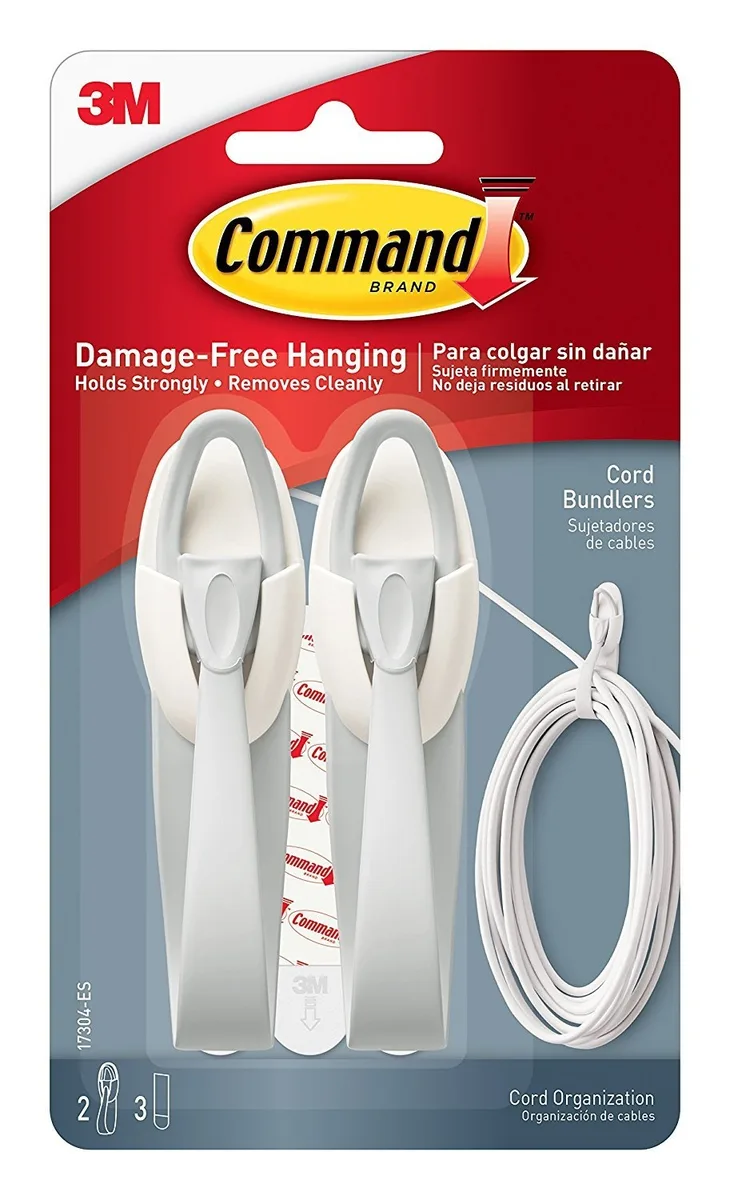 White plastic cord bundlers with adhesive strips on a backing card