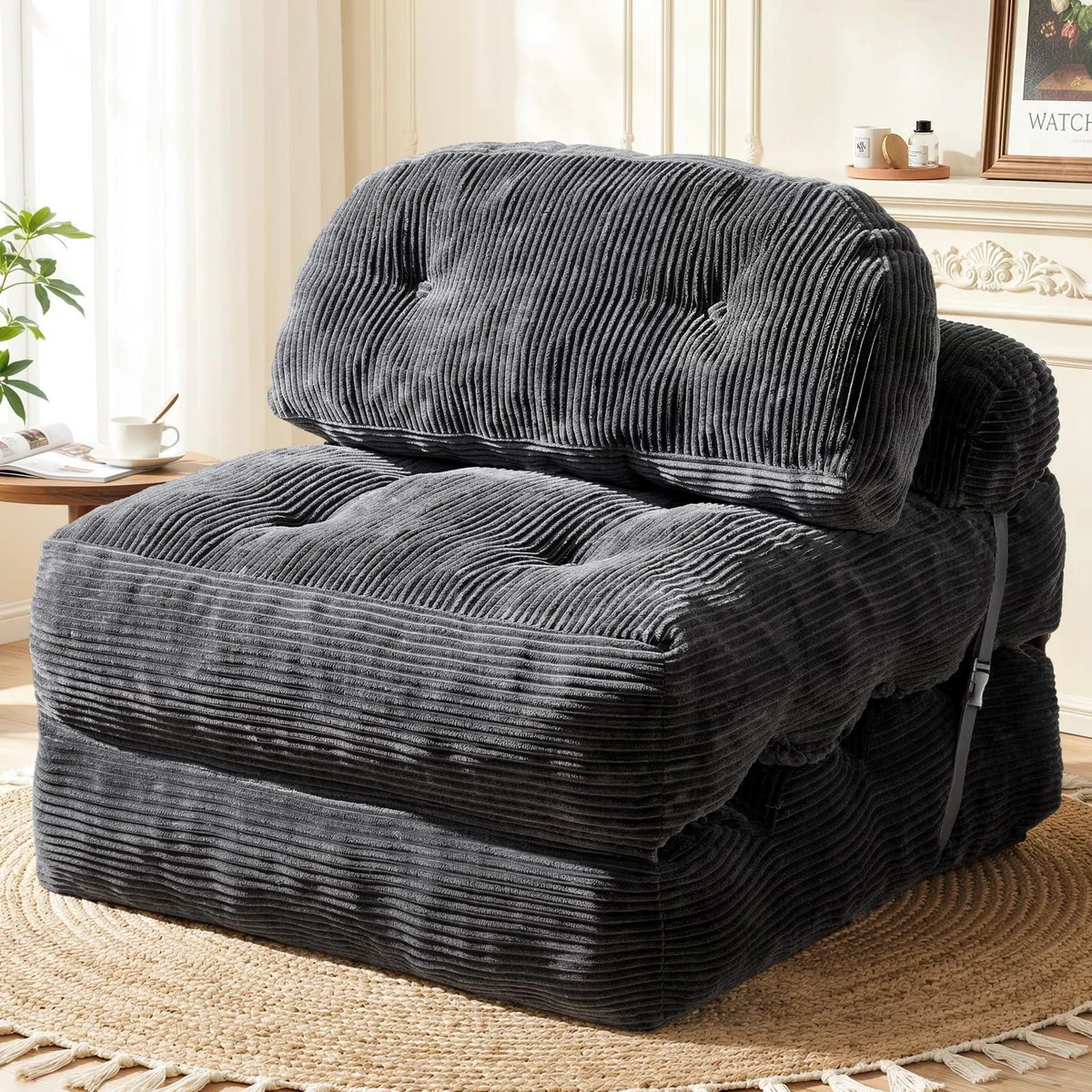 Dark gray corduroy folding sofa bed with detachable pillows and buckle strap, shown unfolded