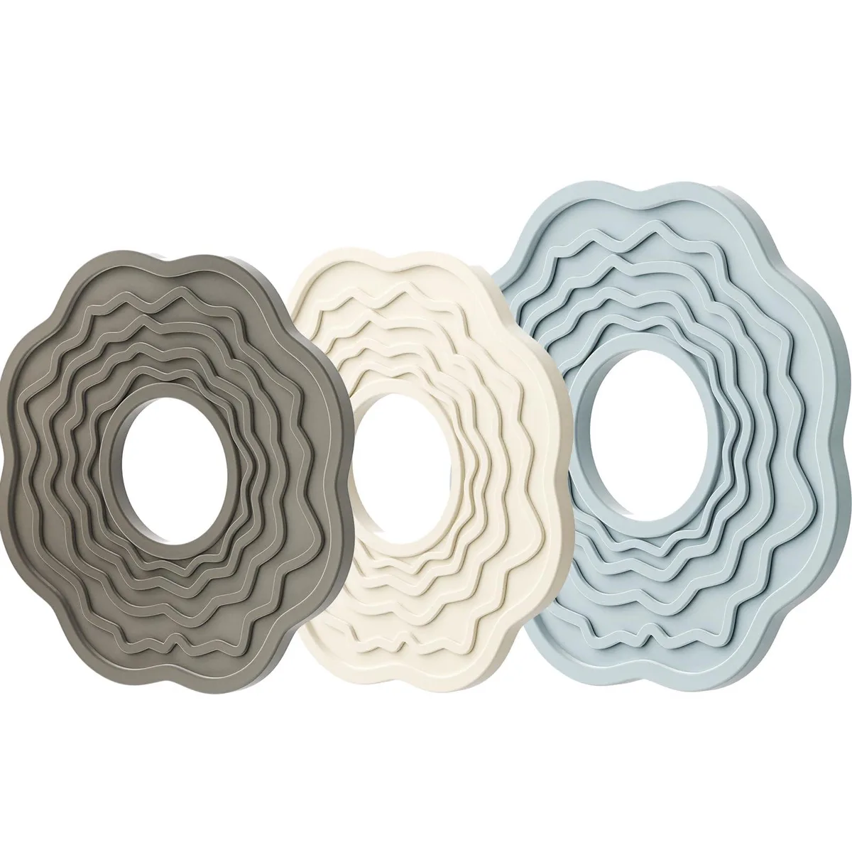 Three silicone trivets in cream blue and gray one large two small with raised grip texture