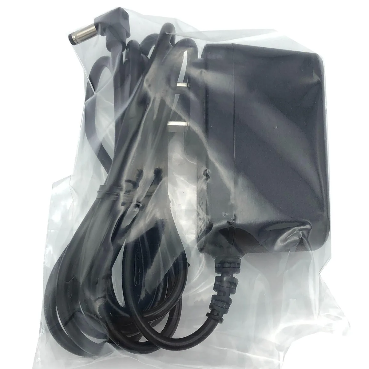 Compact black wall adapter with fixed mains prongs and barrel output lead