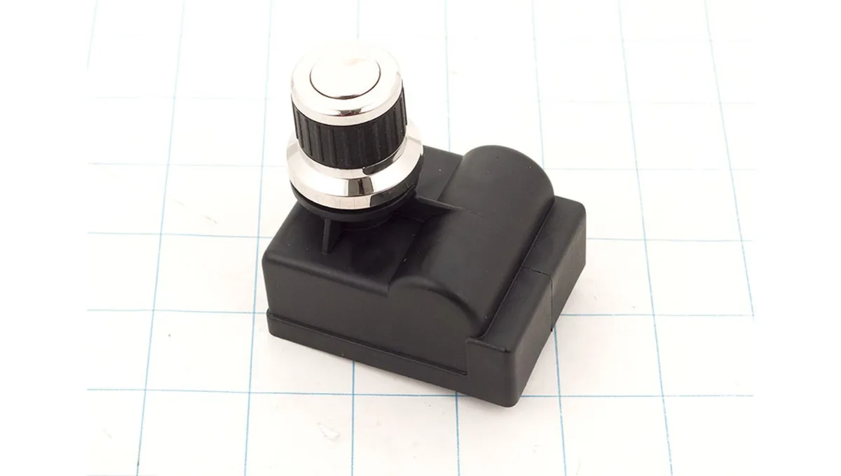 Small black rectangular electronic igniter module with side terminals