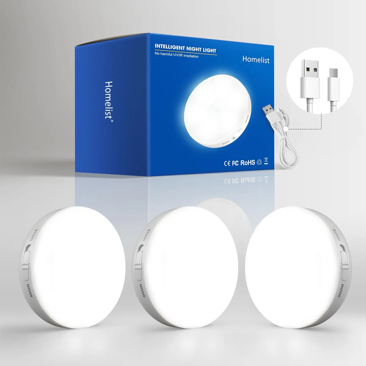 Three white rechargeable puck lights with clear prismatic covers, magnetic mounting plates and a 3-in-1 charging cable