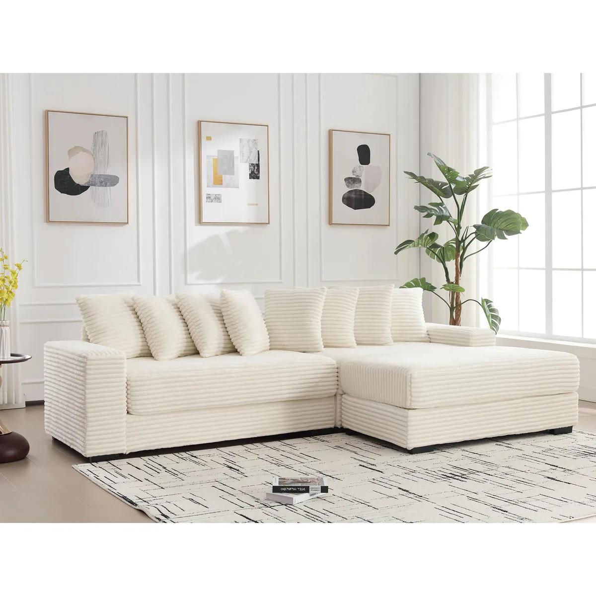 Beige corduroy L-shaped sofa with right chaise and eight matching pillows