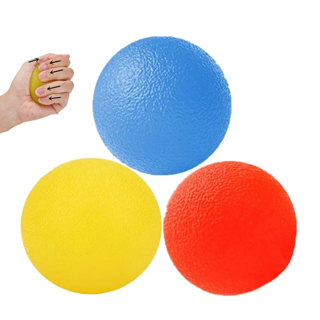 Three small silicone balls in yellow orange and blue on a surface