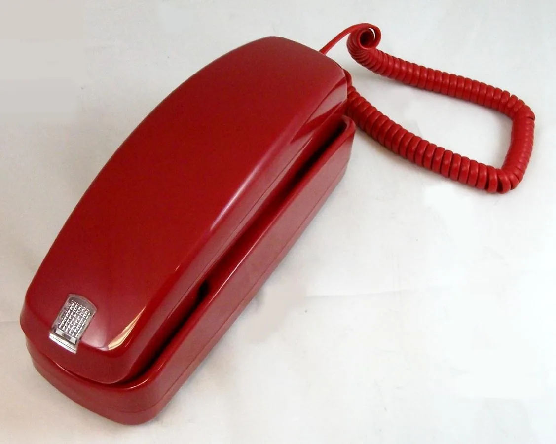 Red corded telephone with lighted dial pad and visual ringer