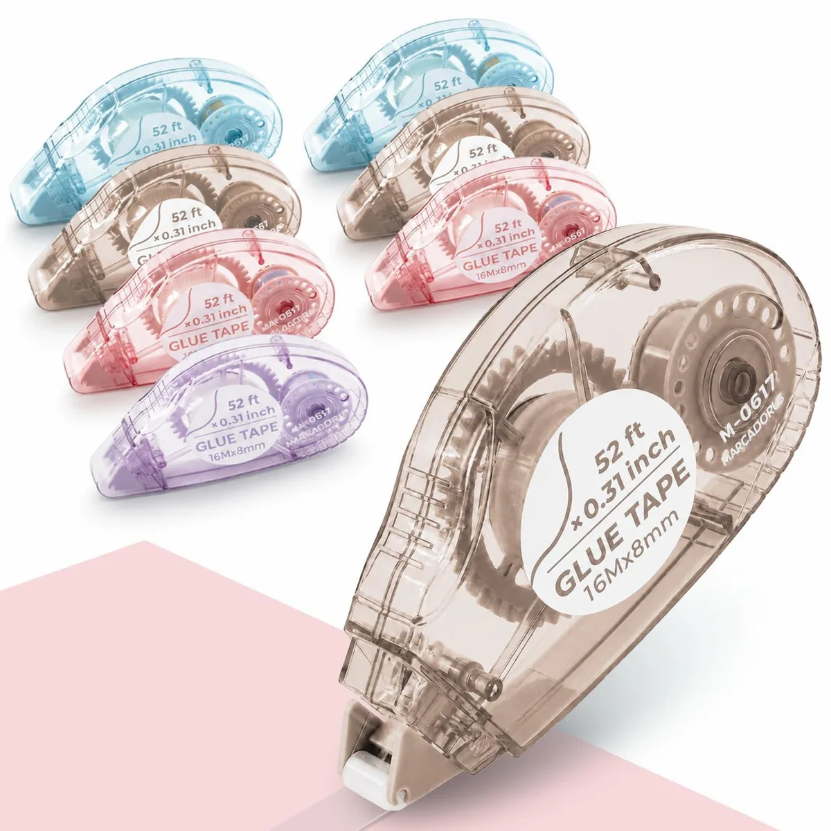 Eight multicoloured plastic tape rollers in clear housings with protective caps