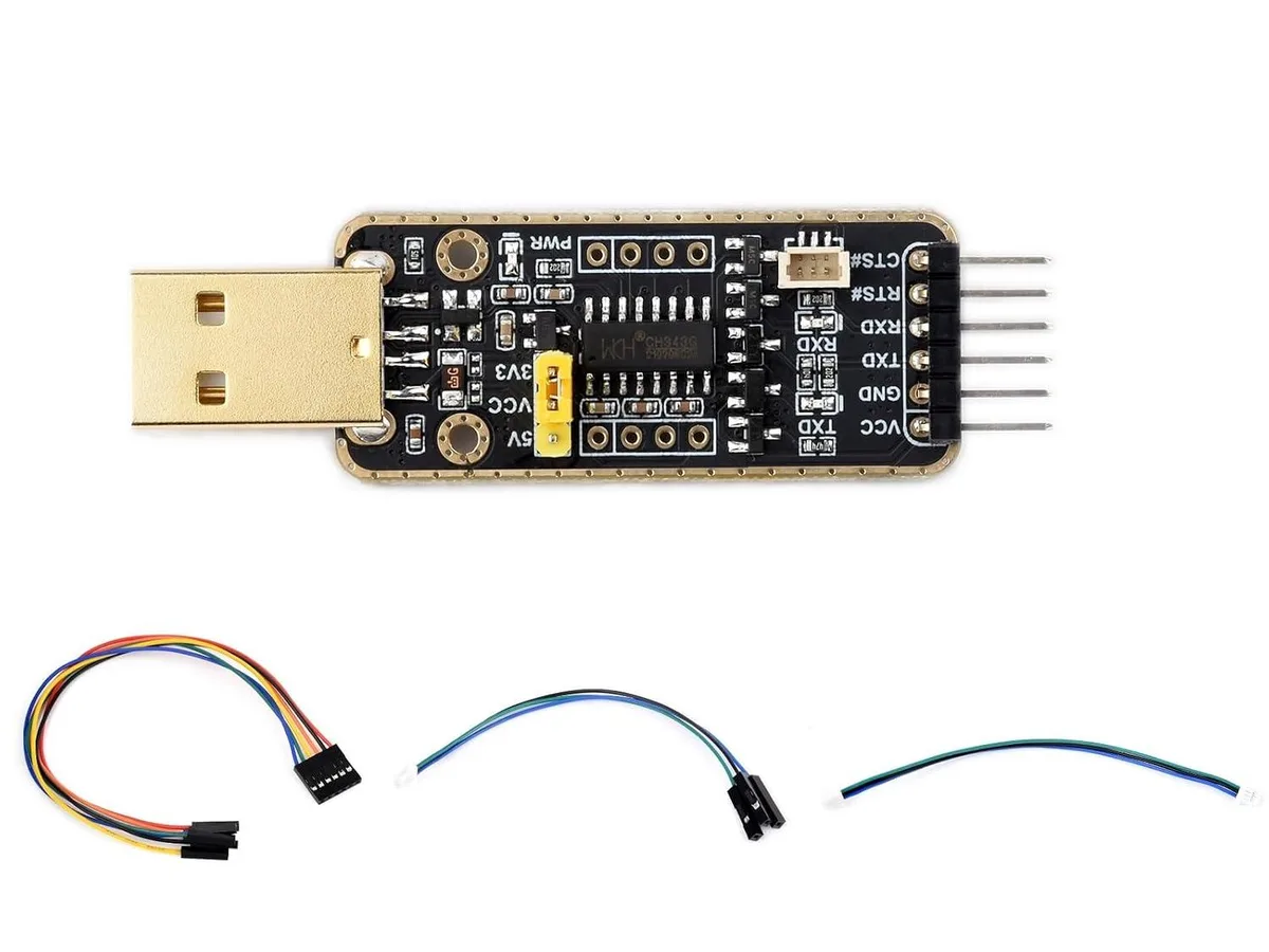 Small black circuit board with USB connector and pin headers, double-sided gold finish