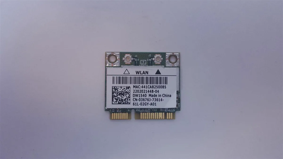 Small green circuit board with gold edge connector and black antenna sockets