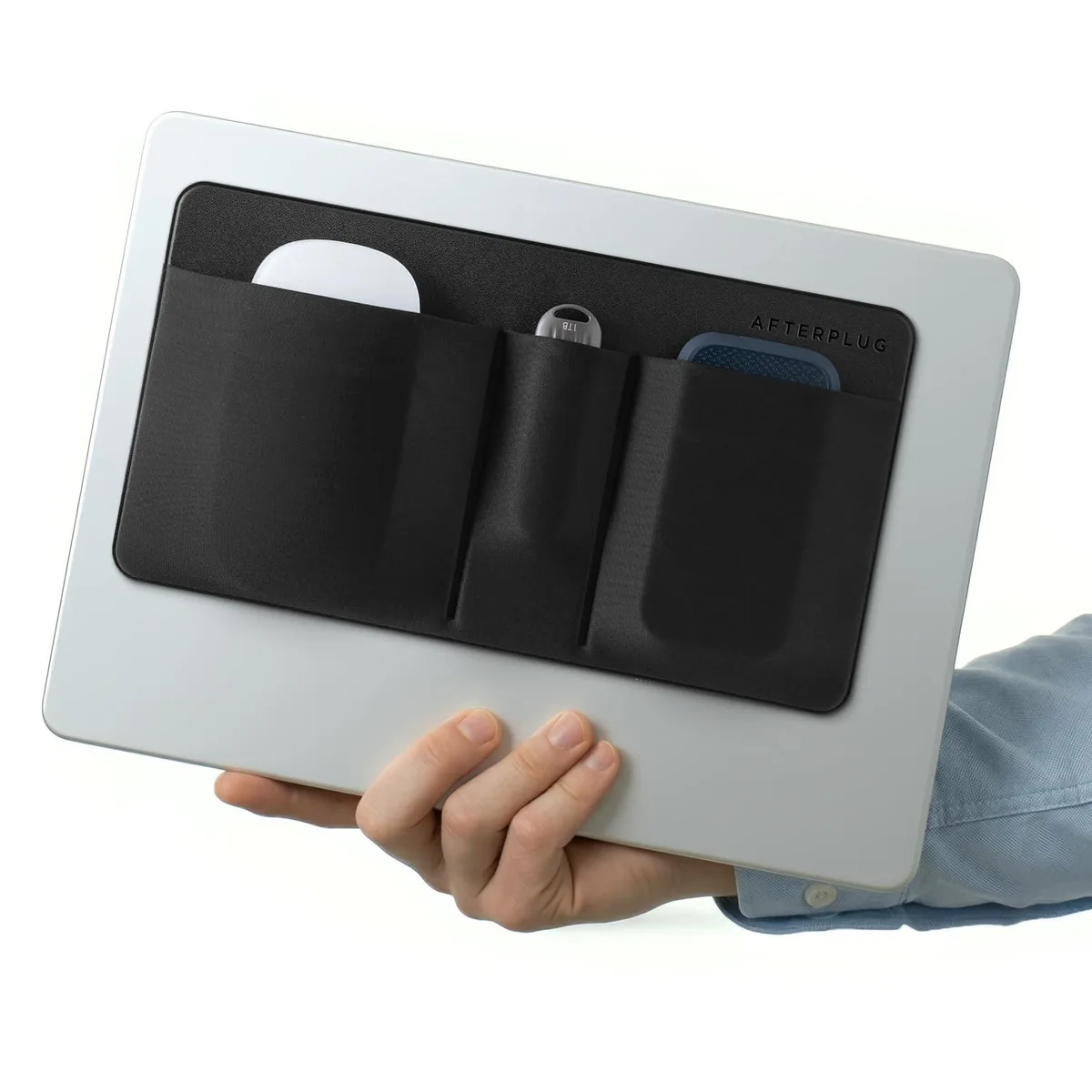 Black adhesive pouch with three pockets and a safety strap attached to a laptop