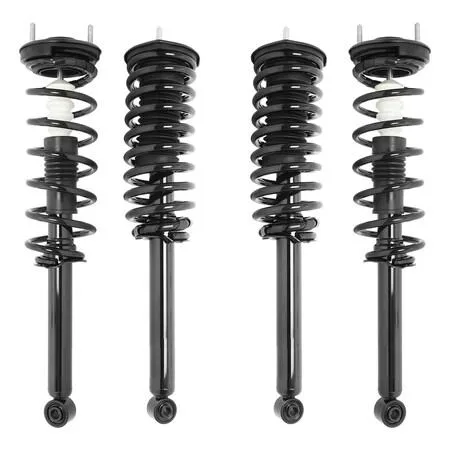 Four silver strut assemblies with black coil springs and top mounts, new condition