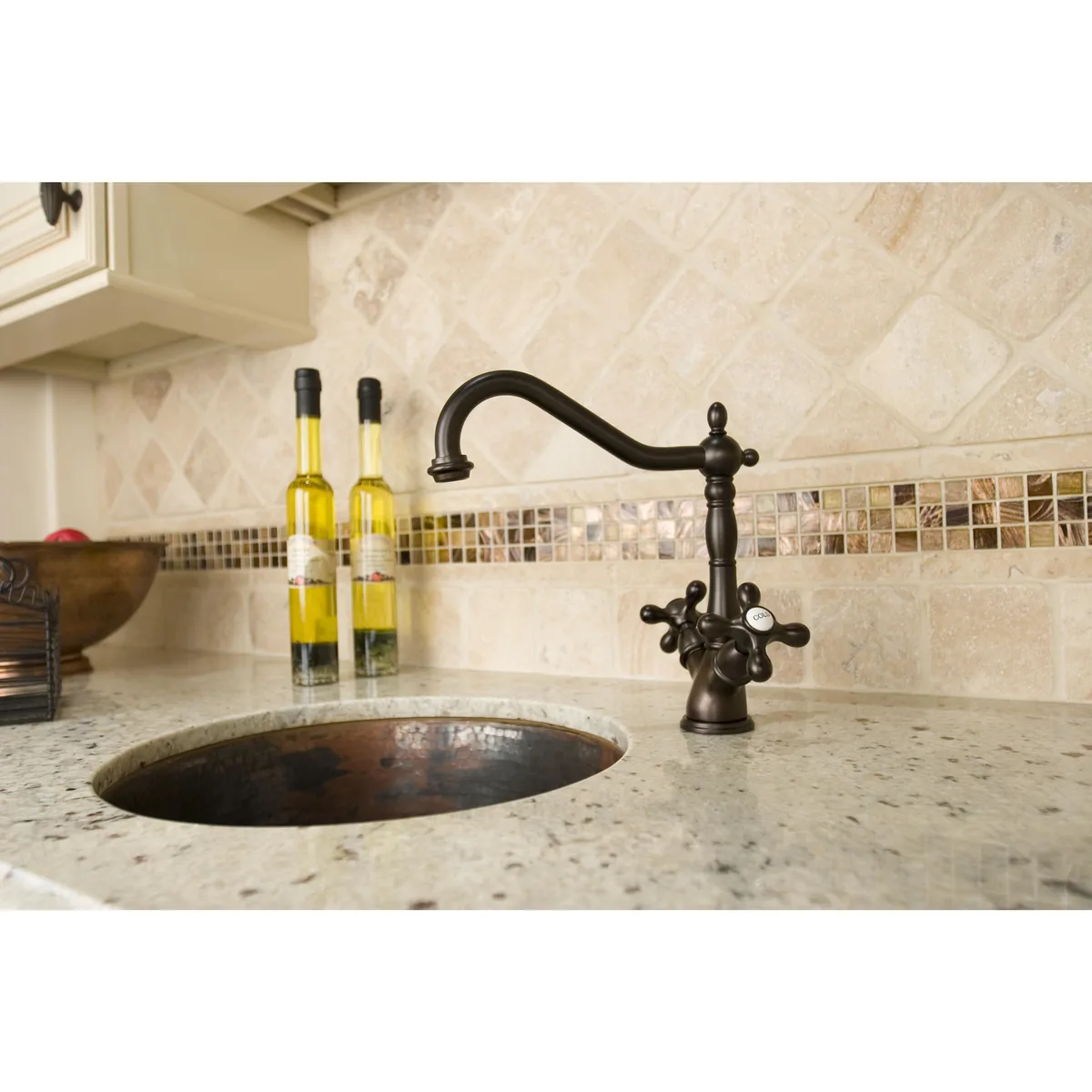 Kingston Brass oil-rubbed bronze single-hole kitchen faucet with matching side-sprayer