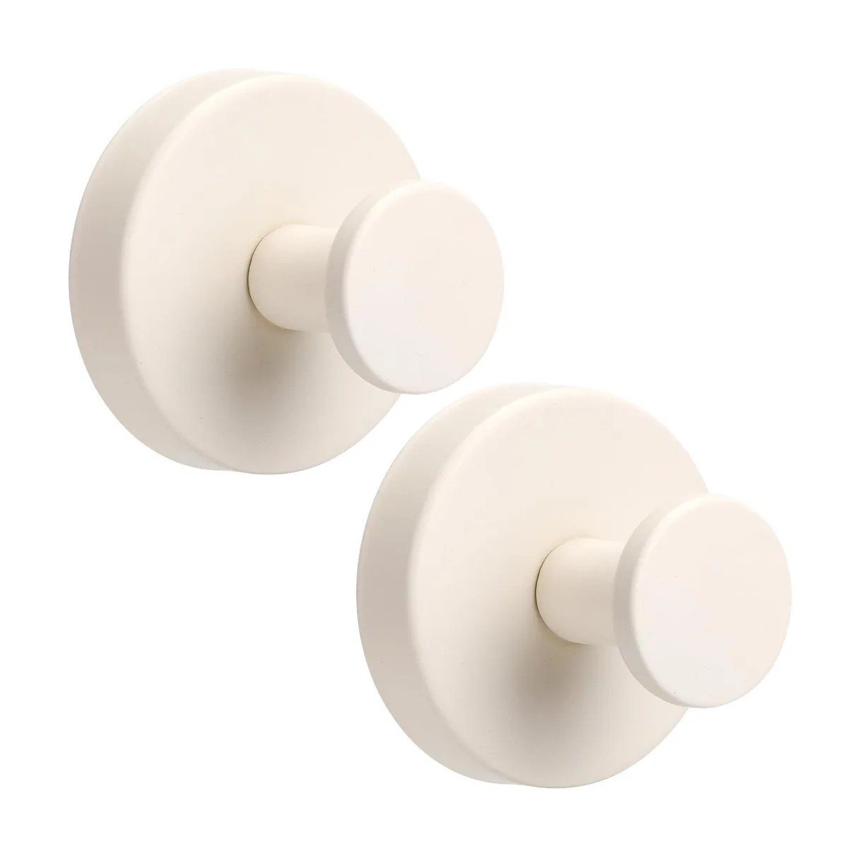 Two milk-white suction cup hooks on a smooth surface
