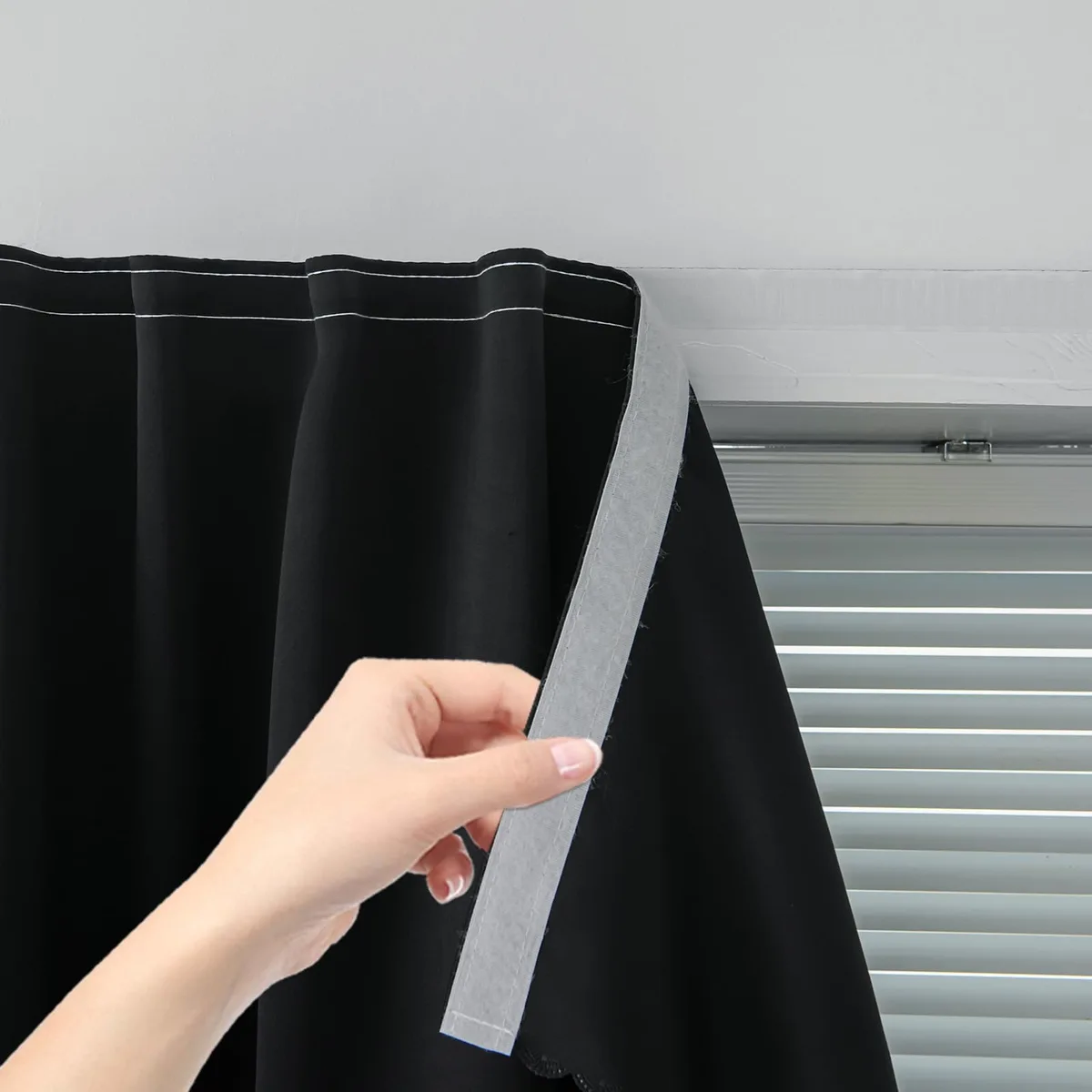 Single black polyester curtain panel with adhesive strips, 35 inches wide by 59 inches long