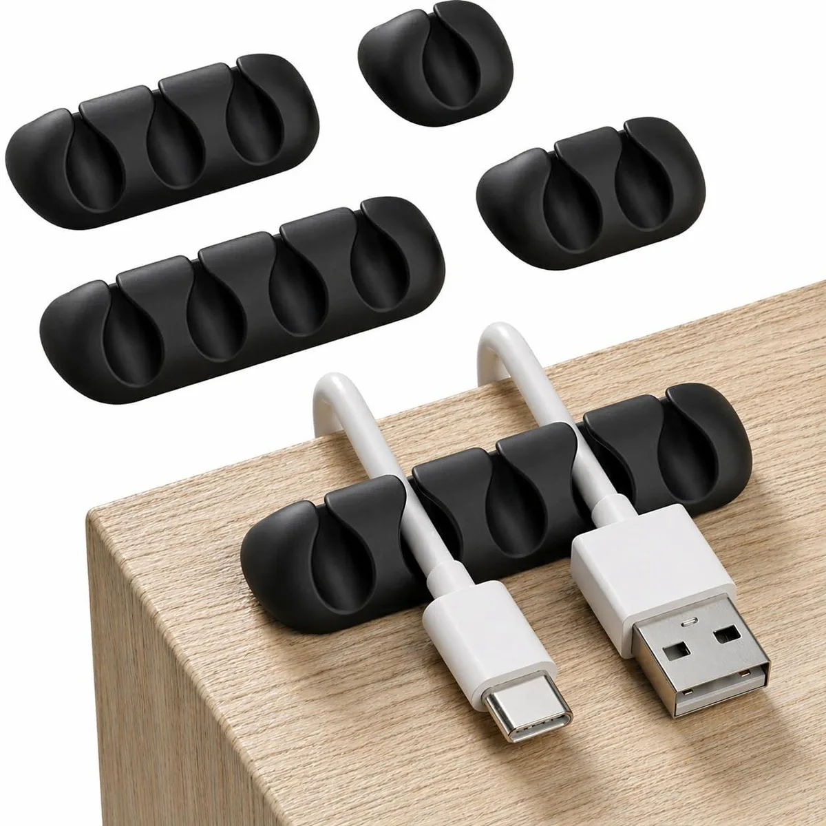 Five black silicone cord organizers with fifteen slots, self-adhesive, 2.2 inches long