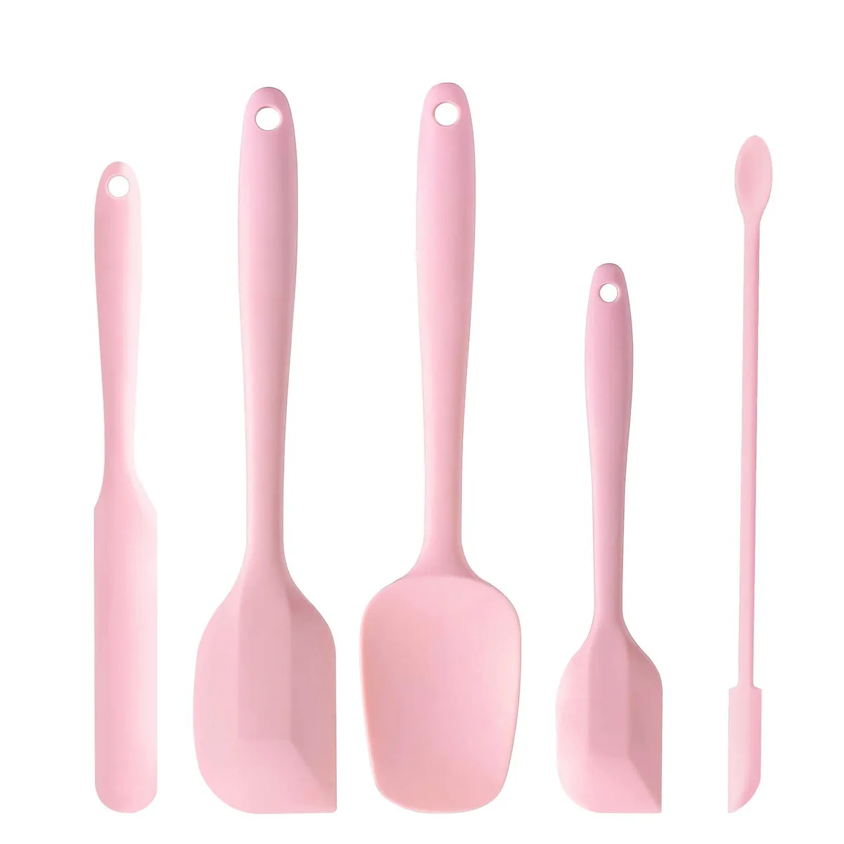 Five pink silicone spatulas in different sizes lying together