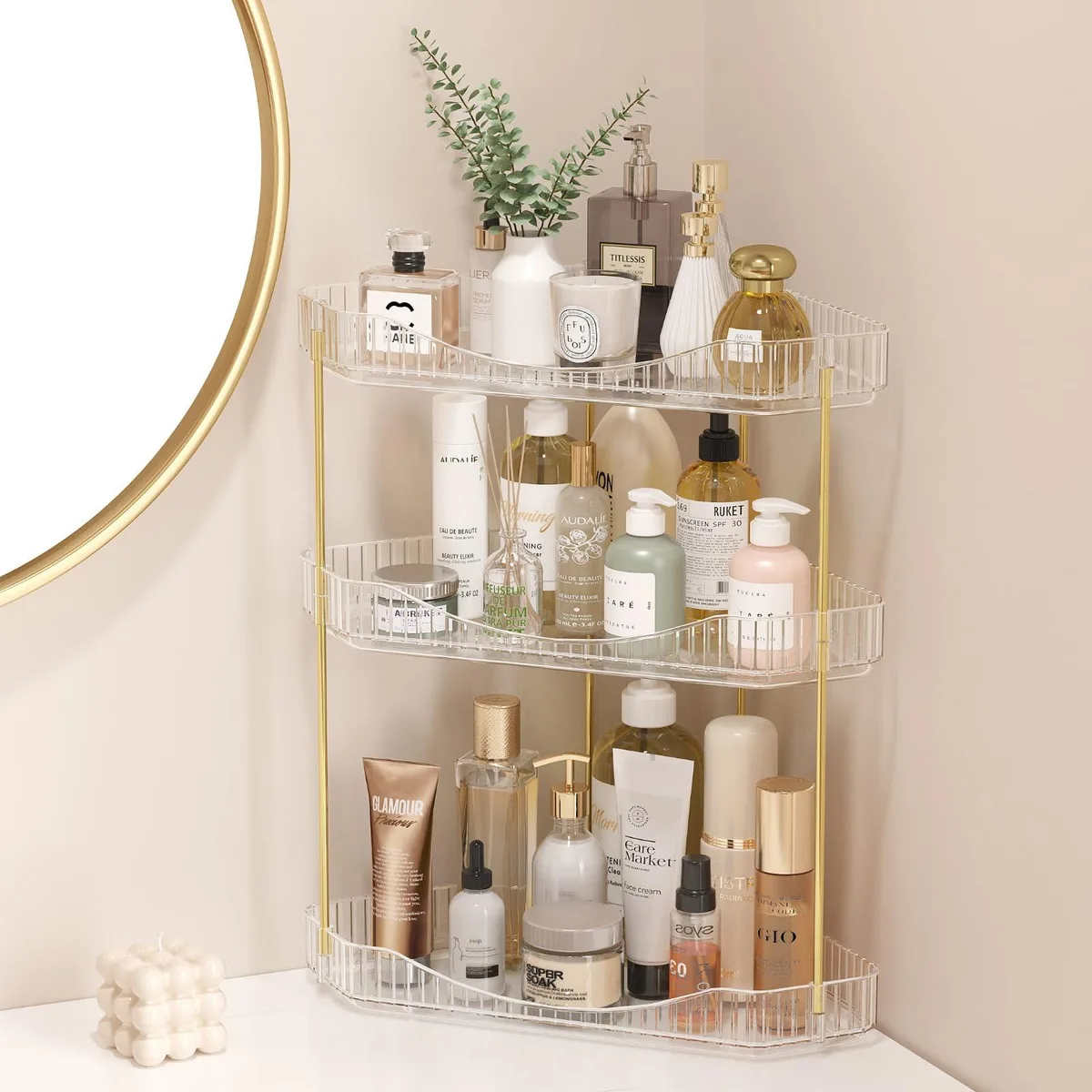 Clear three-tier corner shelf unit with polished metal frame and transparent trays, 26 by 26 by 39.4 cm