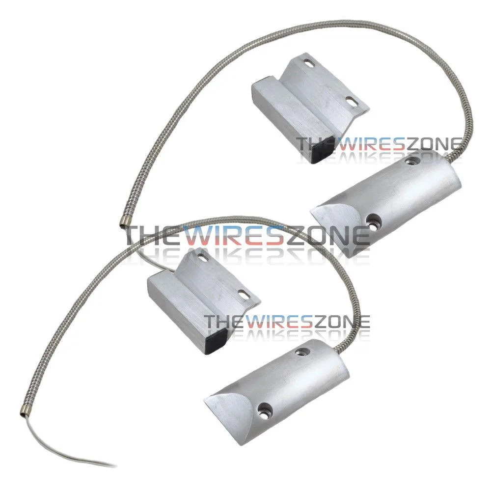 Two white plastic switch units with magnets, brackets and armoured cables