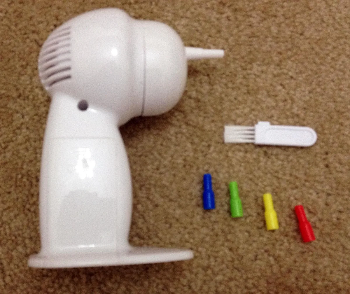White handheld cordless ear vacuum with four coloured soft tips